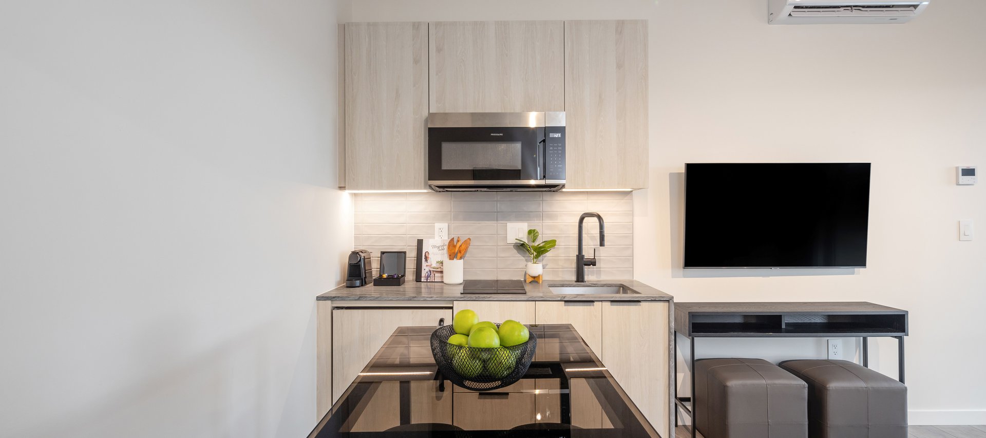 junior one bedroom suite features modern half kitchen with nespresso machine at steveston waterfront hotel