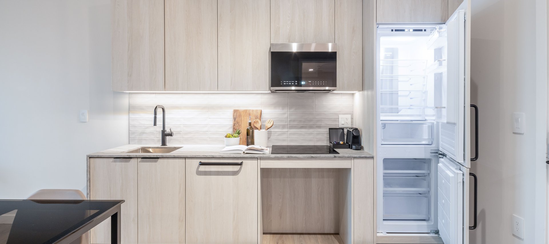 modern kitchen features premium appliances in accessible one bedroom suite