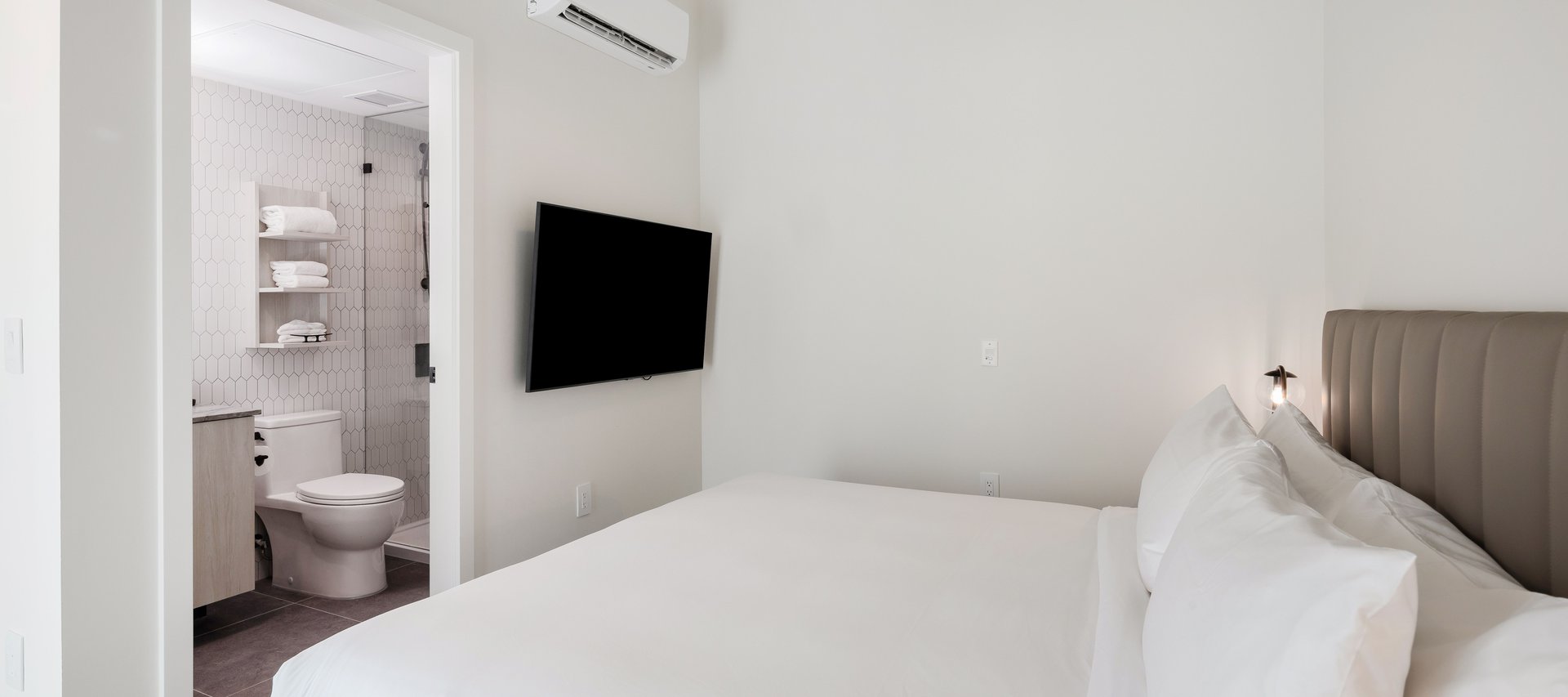 spacious bedroom with premium linen of waterfront one bedroom suite at steveston waterfront hotel in steveston village richmond