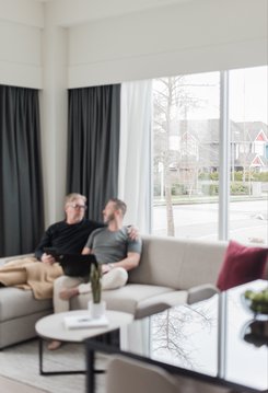 a couple sitting on the couch having conversation at steveston waterfront hotel